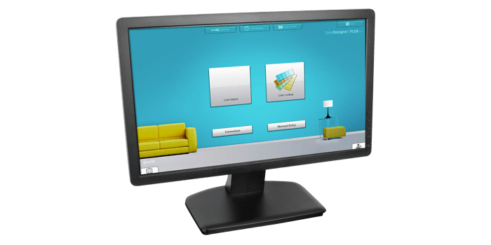 A large desktop computer showing X-Rite color analysis software ColorDesigner PLUS.